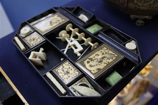 A Chinese export gilt decorated black lacquer sewing box, containing ivory accessories, mid 19th century, 39cm.